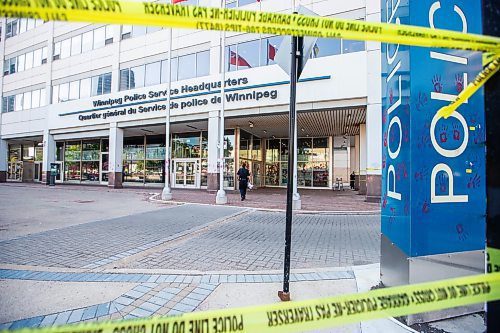 MIKAELA MACKENZIE / WINNIPEG FREE PRESS

Police investigate windows painted with protest messages at the Winnipeg Police Service headquarters on Wednesday, July 26, 2023. For &#x2014; story.
Winnipeg Free Press 2023