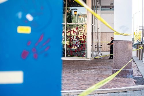 MIKAELA MACKENZIE / WINNIPEG FREE PRESS

Police investigate windows painted with protest messages at the Winnipeg Police Service headquarters on Wednesday, July 26, 2023. For &#x2014; story.
Winnipeg Free Press 2023