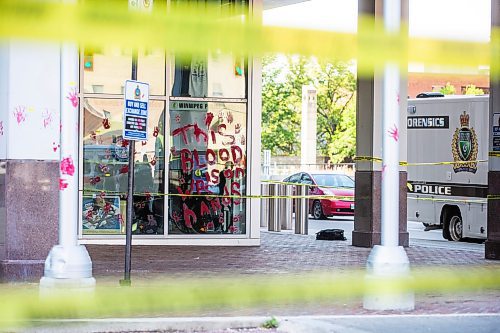 MIKAELA MACKENZIE / WINNIPEG FREE PRESS

Police investigate windows painted with protest messages at the Winnipeg Police Service headquarters on Wednesday, July 26, 2023. For &#x2014; story.
Winnipeg Free Press 2023