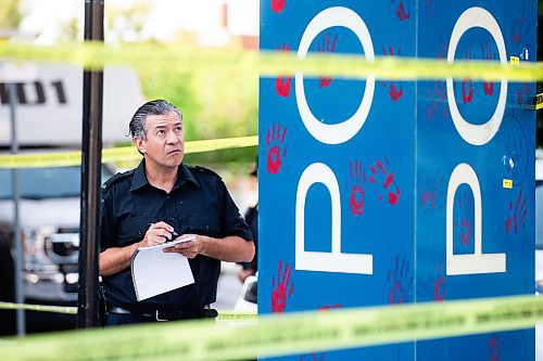 MIKAELA MACKENZIE / WINNIPEG FREE PRESS

Police investigate windows painted with protest messages at the Winnipeg Police Service headquarters on Wednesday, July 26, 2023. For &#x2014; story.
Winnipeg Free Press 2023