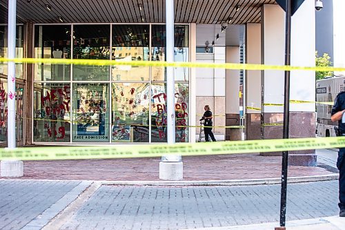 MIKAELA MACKENZIE / WINNIPEG FREE PRESS

Police investigate windows painted with protest messages at the Winnipeg Police Service headquarters on Wednesday, July 26, 2023. For &#x2014; story.
Winnipeg Free Press 2023