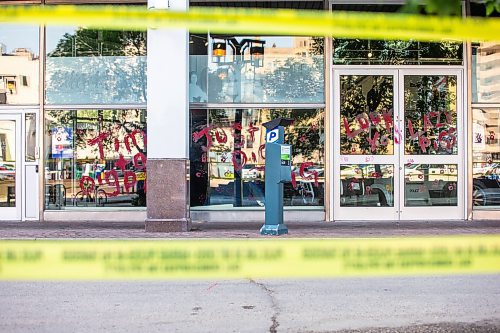 MIKAELA MACKENZIE / WINNIPEG FREE PRESS

Police investigate windows painted with protest messages at the Winnipeg Police Service headquarters on Wednesday, July 26, 2023. For &#x2014; story.
Winnipeg Free Press 2023