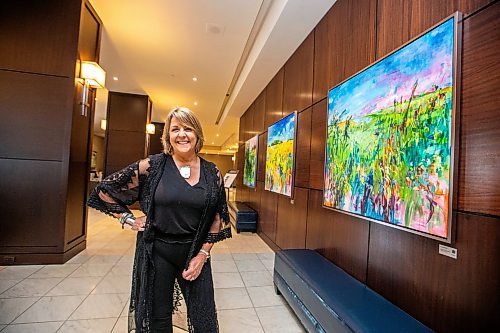 MIKAELA MACKENZIE / WINNIPEG FREE PRESS

Fairmont artist-in-residence Amanda Onchulenko with her paintings in the hotel lobby in Winnipeg on Tuesday, July 25, 2023. For Al Small story.
Winnipeg Free Press 2023