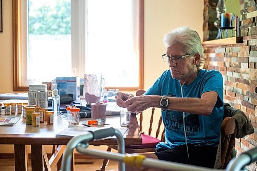 MIKAELA MACKENZIE / WINNIPEG FREE PRESS

Rick Schmidt takes a copious amount of pills at his kitchen table while recovering from a lung transplant on Thursday, July 27, 2023. For John Longhurst story.
Winnipeg Free Press 2023