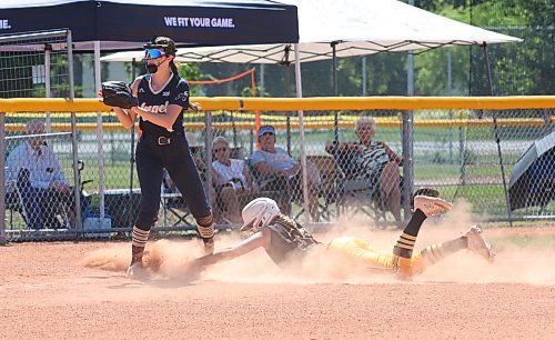 Westman Magic base runner Presley Hodson dives safely into third base as Manitoba Angels third baseman Alexandria MacLean (9) keeps an eye out for the ball during the opening game of Softball Manitoba’s under-15 provincial championship at the Ashley Neufeld Softball Complex on Thursday afternoon. Hodson, who was pitching for the Magic, was injured during the game in a collision with catcher Alexa Banga that sent both players to hospital. (Perry Bergson/The Brandon Sun)