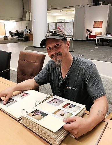 CAROL SANDERS / WINNIPEG FREE PRESS

Crew leader Arron Lavis jokingly looks for his photo in the “book of shame” found at the former Bay downtown by workers clearing it out  - the album contains Polaroids of those banned for life for shoplifting. Lavis said he was 13 when he got caught and was banned. After a troubled youth and a criminal record dogged him, he got a break from the social enterprise non-profit BUILD as a trainee. Eight years later, the 50-year-old is now a trainer with a job and a life he loves and is soon to be wed. 