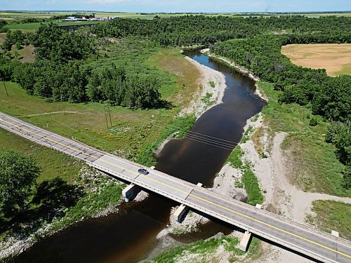 A car passes over the Highway 2 bridge over the Souris River southwest of Wawanesa on Thursday. The bridge will receive upgrades including flood protection measures totalling around $1.7 million, the province announced on Thursday. (Tim Smith/The Brandon Sun)