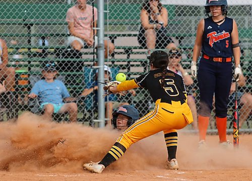 Westman Magic pitcher Jayce Whiteside (5) watches as Manitoba Thunder base runner Sara Holmstrom (19) scores on a passed ball under the watchful eye of her teammate Jaidyn Howard (5) during Thursday evening&#x2019;s game. The Magic won 8-1. (Perry Bergson/The Brandon Sun)