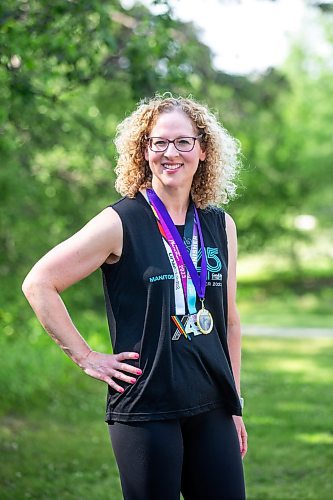 MIKAELA MACKENZIE / WINNIPEG FREE PRESS

Stacey Bazak, who has come to love running while also losing 100 pounds, with medals from races she&#x573; run on Wednesday, July 26, 2023. For Sabrina Carnevale story.
Winnipeg Free Press 2023