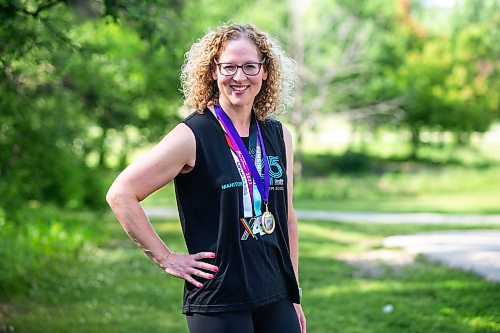 MIKAELA MACKENZIE / WINNIPEG FREE PRESS

Stacey Bazak, who has come to love running while also losing 100 pounds, with medals from races she&#x573; run on Wednesday, July 26, 2023. For Sabrina Carnevale story.
Winnipeg Free Press 2023