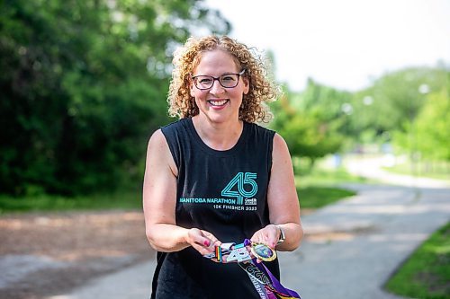 MIKAELA MACKENZIE / WINNIPEG FREE PRESS

Stacey Bazak, who has come to love running while also losing 100 pounds, with medals from races she&#x573; run on Wednesday, July 26, 2023. For Sabrina Carnevale story.
Winnipeg Free Press 2023