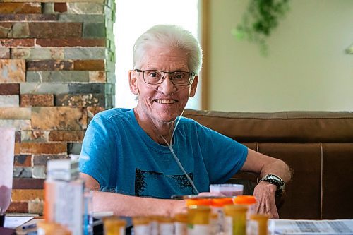 MIKAELA MACKENZIE / WINNIPEG FREE PRESS

Rick Schmidt at his kitchen table (with various medicines, charts, and equipment) while recovering from a lung transplant on Thursday, July 27, 2023. For John Longhurst story.
Winnipeg Free Press 2023