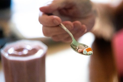 MIKAELA MACKENZIE / WINNIPEG FREE PRESS

Rick Schmidt takes a copious amount of pills at his kitchen table while recovering from a lung transplant on Thursday, July 27, 2023. For John Longhurst story.
Winnipeg Free Press 2023