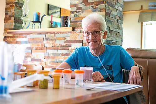 MIKAELA MACKENZIE / WINNIPEG FREE PRESS

Rick Schmidt at his kitchen table (with various medicines, charts, and equipment) while recovering from a lung transplant on Thursday, July 27, 2023. For John Longhurst story.
Winnipeg Free Press 2023