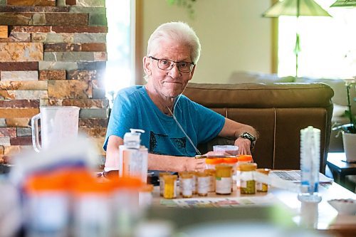 MIKAELA MACKENZIE / WINNIPEG FREE PRESS

Rick Schmidt at his kitchen table (with various medicines, charts, and equipment) while recovering from a lung transplant on Thursday, July 27, 2023. For John Longhurst story.
Winnipeg Free Press 2023