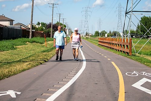 MIKAELA MACKENZIE / WINNIPEG FREE PRESS

Marcel Chartier and Sandra Kolter walk down the new Northwest Hydro Corridor Multi-Use Path on Thursday, July 27, 2023. For &#x460;story.
Winnipeg Free Press 2023