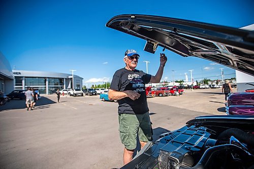 MIKAELA MACKENZIE / WINNIPEG FREE PRESS

Grant McKay opens up the hood on his &#x576;9 442 Cutlass at the first annual Show &amp; Shine car show at the Gauthier Cadillac Experience Centre on Thursday, July 27, 2023. Standup.
Winnipeg Free Press 2023