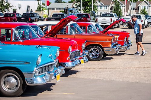 MIKAELA MACKENZIE / WINNIPEG FREE PRESS

Russ St. Germain opens up the hood on his &#x575;7 Chevrolet at the first annual Show &amp; Shine car show at the Gauthier Cadillac Experience Centre on Thursday, July 27, 2023. Standup.
Winnipeg Free Press 2023