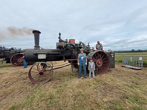 Thomas (from left), Noah and Andrew Beamish stand in front of their 1913 75 Case 75-HP steam traction engine. (Photos by Miranda Leybourne/The Brandon Sun)