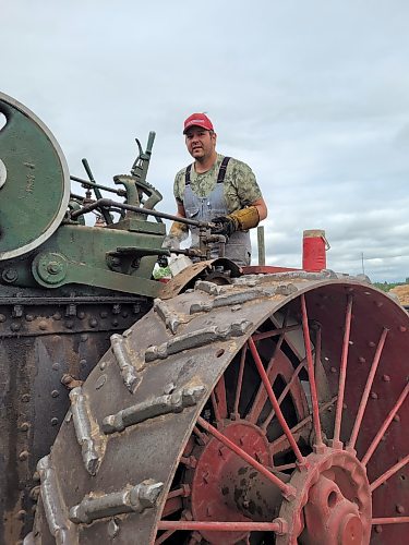 Andrew Beamish at the helm of a 1913 75 Case 75-HP steam traction engine. (Miranda Leybourne/The Brandon Sun)