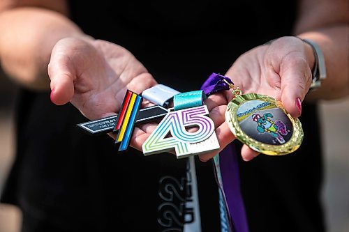 MIKAELA MACKENZIE / WINNIPEG FREE PRESS

Stacey Bazak, who has come to love running while also losing 100 pounds, with medals from races she&#x573; run on Wednesday, July 26, 2023. For Sabrina Carnevale story.
Winnipeg Free Press 2023