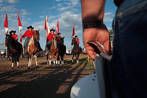 27072023
Riders prepare to carry Canadian flags for the national anthem before the first go-round of the Manitoba Threshermen&#x2019;s Reunion and Stampede rodeo near Austin, Manitoba on Thursday evening.  (Tim Smith/The Brandon Sun)
