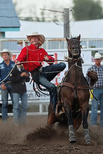 27072023
Walker Warkentin of Calmar, AB, leaps off his horse after roping a calf during the tie down roping event at the first go-round of the Manitoba Threshermen&#x2019;s Reunion and Stampede rodeo near Austin, Manitoba on Thursday evening.  (Tim Smith/The Brandon Sun)