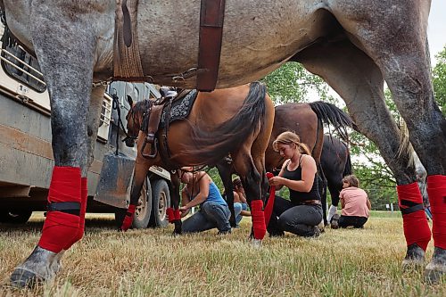 27072023
Sisters Josie, Rachel, Jessica and Lissie Bouer get their horses ready before performing in the grand entry and national anthems during the first go-round of the Manitoba Threshermen&#x2019;s Reunion and Stampede rodeo near Austin, Manitoba on Thursday evening.  (Tim Smith/The Brandon Sun)