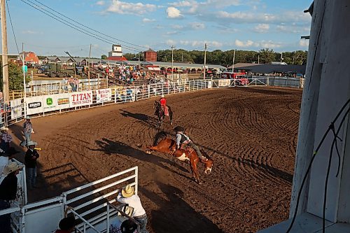 27072023
A cowboy explodes out of a chute on a horse during the bareback riding event at the first go-round of the Manitoba Threshermen&#x2019;s Reunion and Stampede rodeo near Austin, Manitoba on Thursday evening.  (Tim Smith/The Brandon Sun)