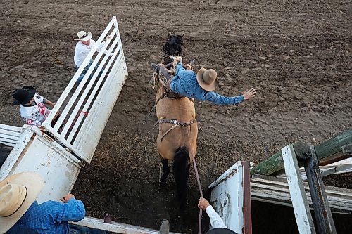 27072023
A cowboy explodes out of a chute on a horse during the saddle bronc event at the first go-round of the Manitoba Threshermen&#x2019;s Reunion and Stampede rodeo near Austin, Manitoba on Thursday evening.  (Tim Smith/The Brandon Sun)