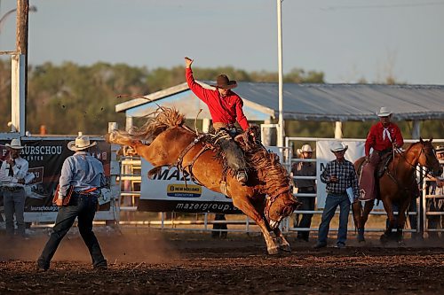 27072023
Cache Schellenberg of Cochrane, Alberta is bucked but holds on during the saddle bronc event at the first go-round of the Manitoba Threshermen&#x2019;s Reunion and Stampede rodeo near Austin, Manitoba on Thursday evening.  (Tim Smith/The Brandon Sun)