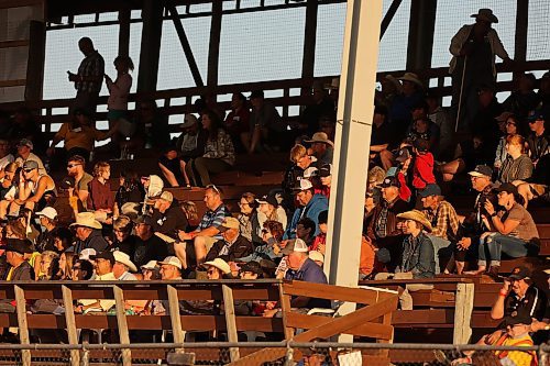 27072023
Rodeo fans watch the saddle bronc event from the grandstand at the first go-round of the Manitoba Threshermen&#x2019;s Reunion and Stampede rodeo near Austin, Manitoba on Thursday evening.  (Tim Smith/The Brandon Sun)