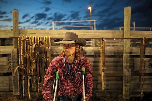 27072023
Bull rider Jaden Ozirney stands on crutches behind the chutes at the end of the first rodeo go-round during the Manitoba Threshermen&#x2019;s Reunion and Stampede near Austin, Manitoba on Thursday evening.  (Tim Smith/The Brandon Sun)