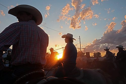 27072023
Cowboys wait to compete in team roping as the sun sets during the first night of rodeo action at the Manitoba Threshermen&#x2019;s Reunion and Stampede near Austin, Manitoba on Thursday evening.  (Tim Smith/The Brandon Sun)