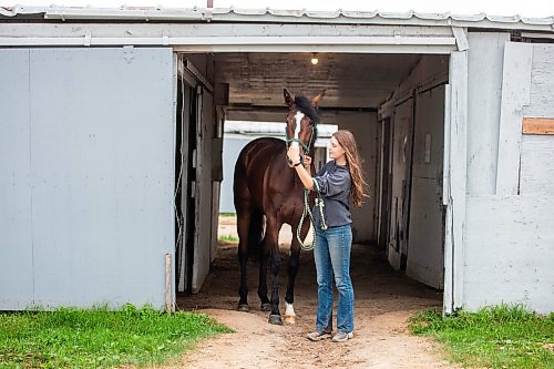 MIKAELA MACKENZIE / WINNIPEG FREE PRESS

Olive Johnston and horse Commandoslastdance, debutante stakes winner, at the Assiniboia Downs barns on Friday, July 28, 2023. For George Williams story.
Winnipeg Free Press 2023