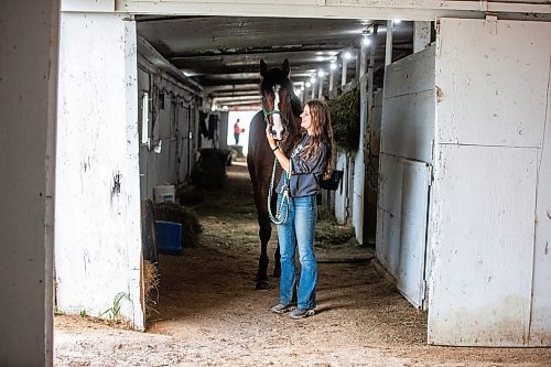 MIKAELA MACKENZIE / WINNIPEG FREE PRESS

Olive Johnston and horse Commandoslastdance, debutante stakes winner, at the Assiniboia Downs barns on Friday, July 28, 2023. For George Williams story.
Winnipeg Free Press 2023