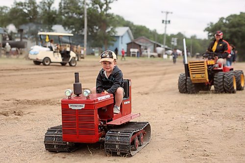 28072023
Brooks Combot of St. Eustache rides a miniature tractor while making his way to take part in the Pioneer power parade at the Manitoba Threshermen&#x2019;s Reunion and Stampede near Austin, Manitoba on Friday afternoon.  (Tim Smith/The Brandon Sun)