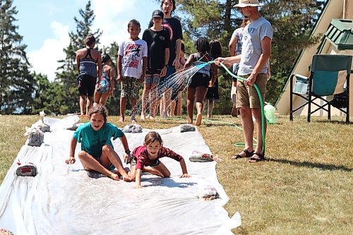 Outside providing some free barbecue, Bethel Christian Assembly also gave local families the chance to try out their homemade slip-and-slide during the second annual “Brandon’s Biggest Water Fight” event. (Kyle Darbyson/The Brandon Sun)