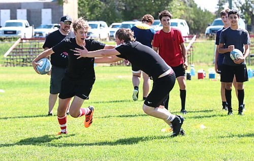 Grady Yon, with the ball on the left, pushes away from a tackler on Sunday at John Reilly field during a final practice for Rugby Manitoba&#x2019;s under-16 provincial team before they head out to Calgary for westerns this week. (Perry Bergson/The Brandon Sun)
July 30, 2023