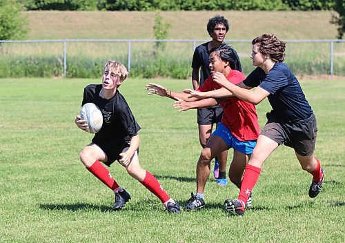 Gavyn Yon, with the ball on the left, feints away from a pair of tacklers on Sunday at John Reilly field during a final practice for Rugby Manitoba&#x2019;s under-16 provincial team before they head out to Calgary for westerns this week. (Perry Bergson/The Brandon Sun)
July 30, 2023