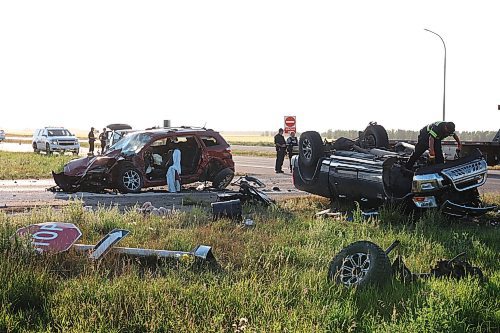 RCMP officers and tow truck operators work at the scene of a three-vehicle collision at the intersection of Highway 5 and the Trans-Canada Highway just north of Carberry on Monday evening. Three people involved were taken to hospital. The collision happened at the same location as the June 15 collision between a bus and a semi trailer that claimed the lives of 17 passengers. (Tim Smith/The Brandon Sun)