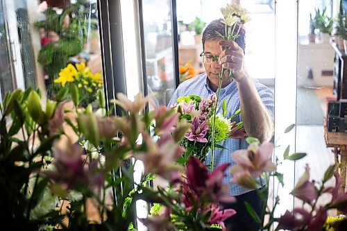 MIKAELA MACKENZIE / WINNIPEG FREE PRESS

Ernest Cholakis, co-owner of Broadway Florists, puts together a bouquet at the flower shop on Academy on Monday, July 31, 2023. They are celebrating 100 years open this September. For Gabby Piche story.
Winnipeg Free Press 2023
