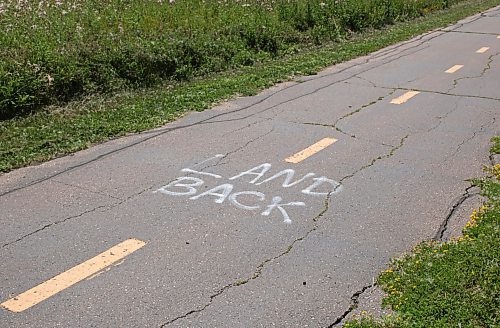 Mike Thiessen / Winnipeg Free Press 
Anti-police slogans were spray painted on the River Road bike path, part of the World Police and Fire Games mini-marathon track. For Erik Pindera. 230731 &#x2013; Monday, July 31, 2023