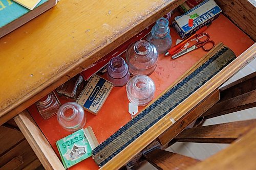 MIKE DEAL / WINNIPEG FREE PRESS
Empty ink bottles and a strap sit in the teachers desk in the Poplar Heights School in the Arborg &amp; District Multicultural Heritage Village in Arborg, MB.
230731 - Monday, July 31, 2023.