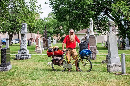 MIKAELA MACKENZIE / WINNIPEG FREE PRESS

Mic Whitty, who is on his eighth year of cycling around the world visiting every cemetery where a Commonwealth World War One or Two causality is buried, at the St. Boniface Cathedral cemetery on the cross-Canada leg of his journey on Tuesday, Aug. 1, 2023. For Cierra Bettens story.
Winnipeg Free Press 2023