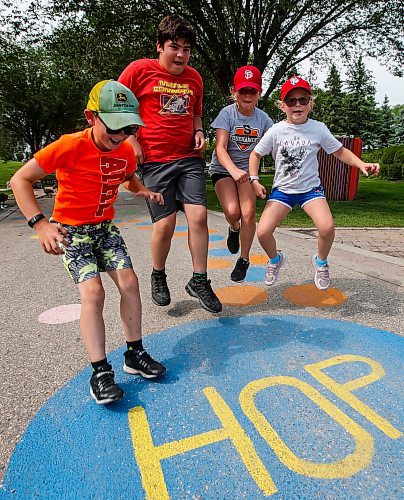 JOHN WOODS / WINNIPEG FREE PRESS
Eric, from left, Thomas, Emily, and Alexa hop as they use a walkway which is part of the Play At The Forks program at The Forks in Winnipeg, Tuesday, August 1, 2023. 

Reporter:
