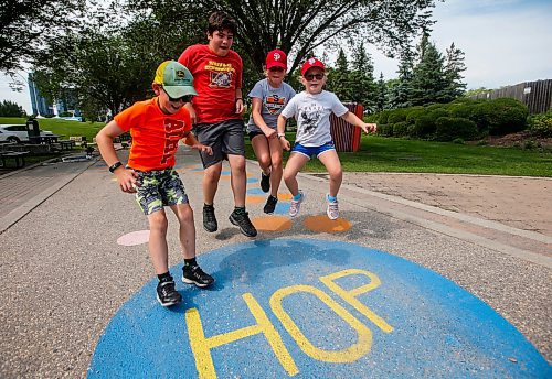 JOHN WOODS / WINNIPEG FREE PRESS
Eric, from left, Thomas, Emily, and Alexa hop as they use a walkway which is part of the Play At The Forks program at The Forks in Winnipeg, Tuesday, August 1, 2023. 

Reporter: