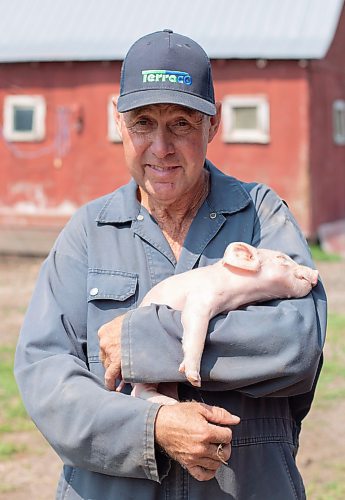 Mike Thiessen / Winnipeg Free Press 
Ian Smith with one of his two-day-old piglets. Smith, a small-scale pork farmer, feels that large corporations have taken over the pork industry, making it increasingly difficult for smaller producers like himself to make a living. For Gabrielle Piché. 230803 – Thursday, August 3, 2023