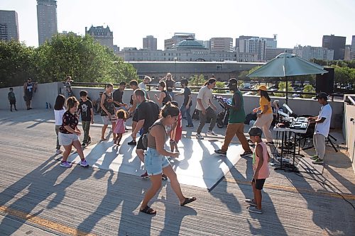 Mike Thiessen / Winnipeg Free Press 
Even in the 32&#x2103; heat, plenty of people came out for the outdoor dance sessions on the roof of the Forks parkade, hosted by Eugene &#x201c;Genie&#x201d; Bafoe and Marvin Joseph &#x201c;bboy majo&#x201d; Barawid. For Eva Wasney. 230802 &#x2013; Wednesday, August 2, 2023