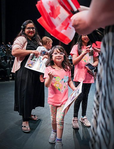 RUTH BONNEVILLE / WINNIPEG FREE PRESS  

Standup - Citizenship ceremony 

Waniya Rehan Siddiqi  (5yrs, centre), is all smiles as she reaches to for a small Canadian Flag after her and members of her family became Canadian citizens along with eight other families at a ceremony held at CCFM,  Centre culturel franco-manitobain Thursday. 
 
The citizenship ceremony took place in conjunction with the kickoff of this years Folklorama Festival with  Pavilion Ambassadors in attendance welcoming in the new citizens after the event.  

Aug 3rd, 2023
